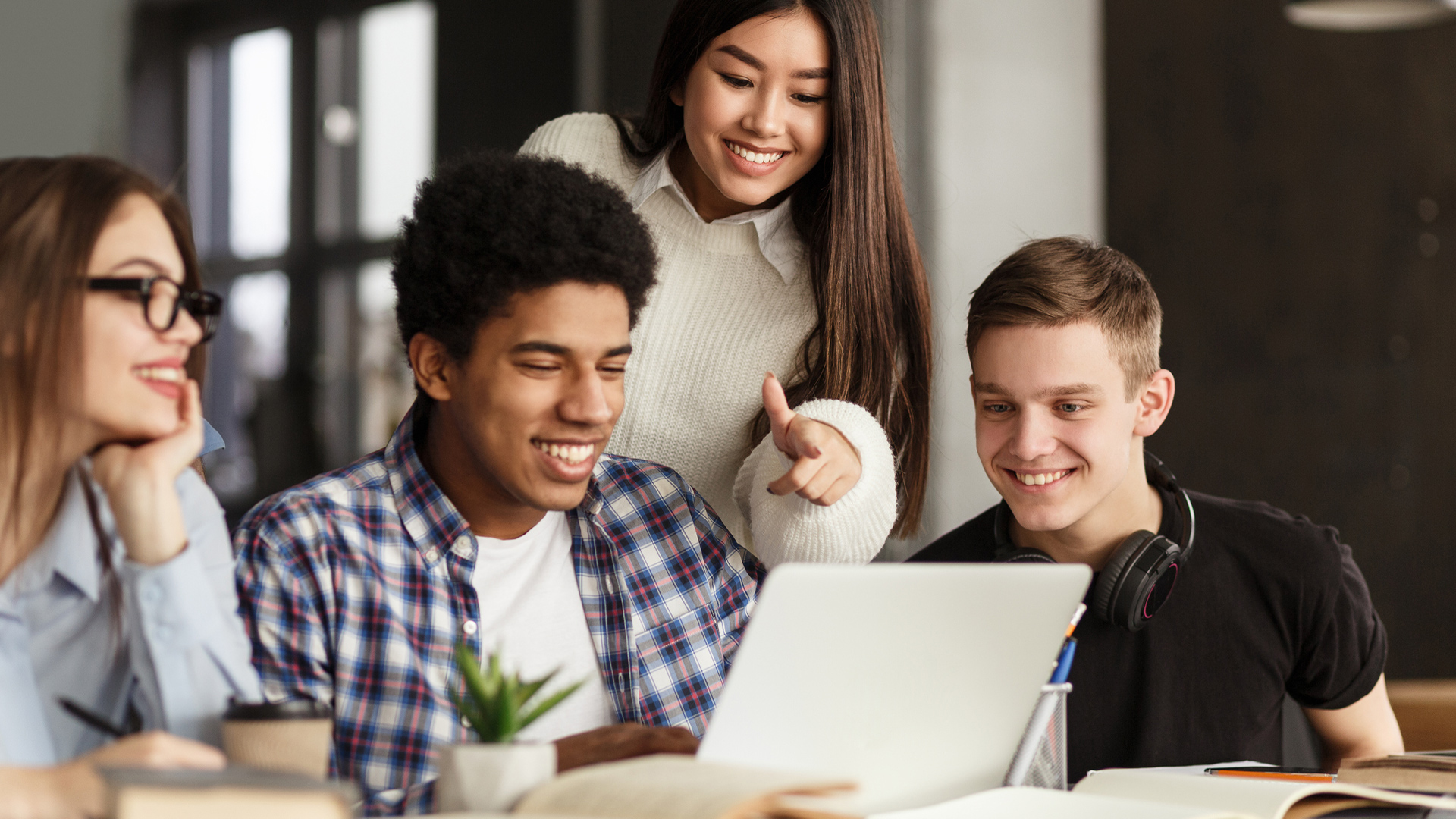 students gathered around laptop
