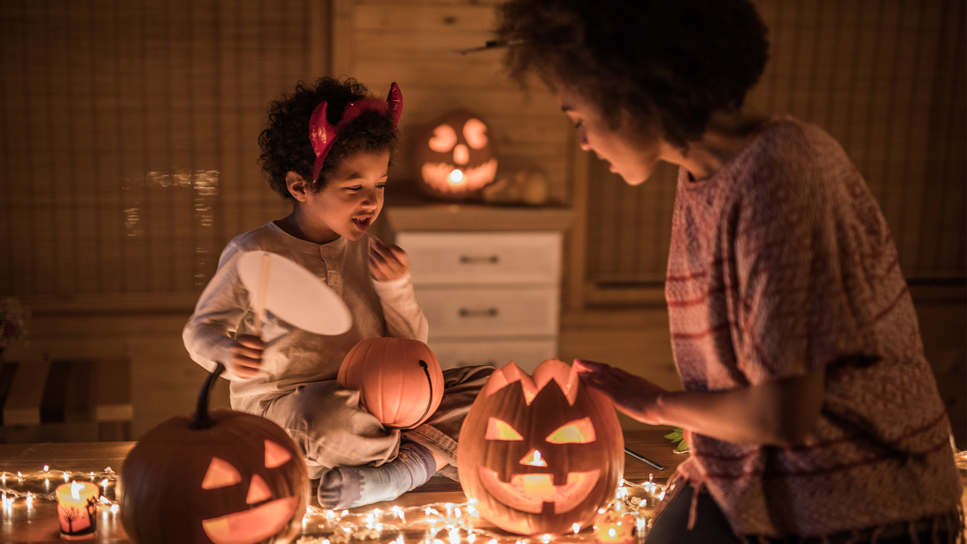 mom and kid decorating for halloween