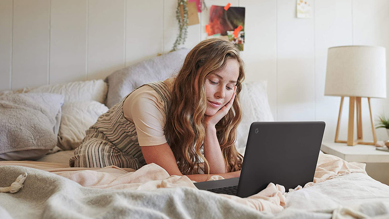 girl on bed using laptop