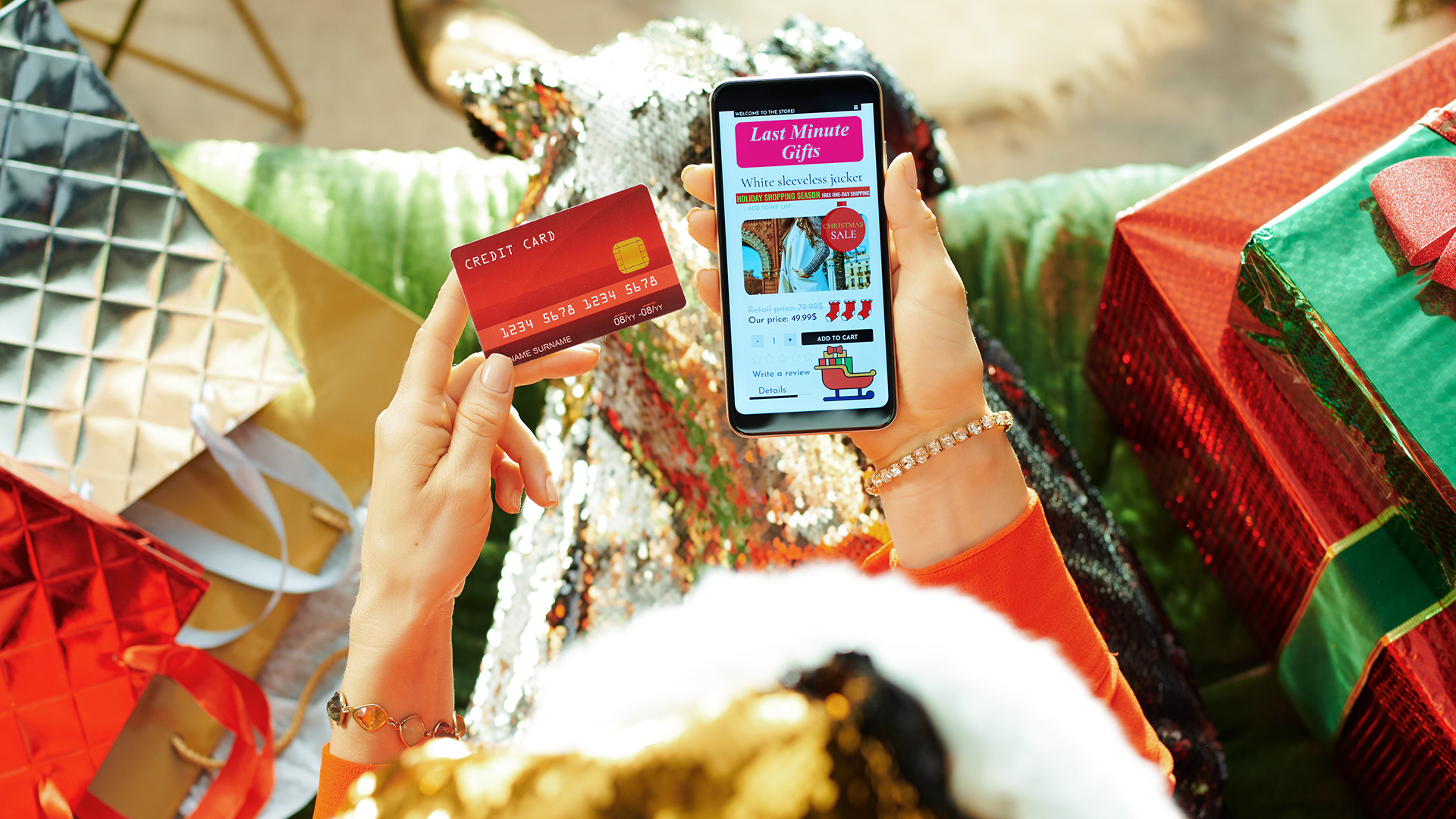 woman shopping christmastime phone credit card packages hero