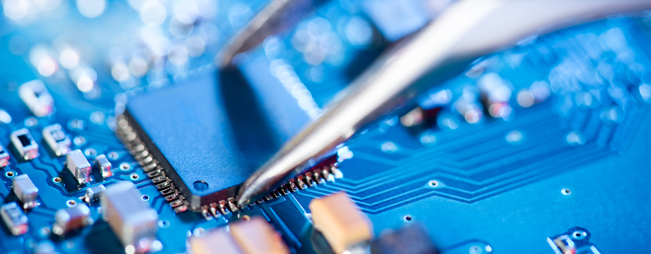 Electronic-technician-holding-tweezers-and-assemblin-a-circuit-boar