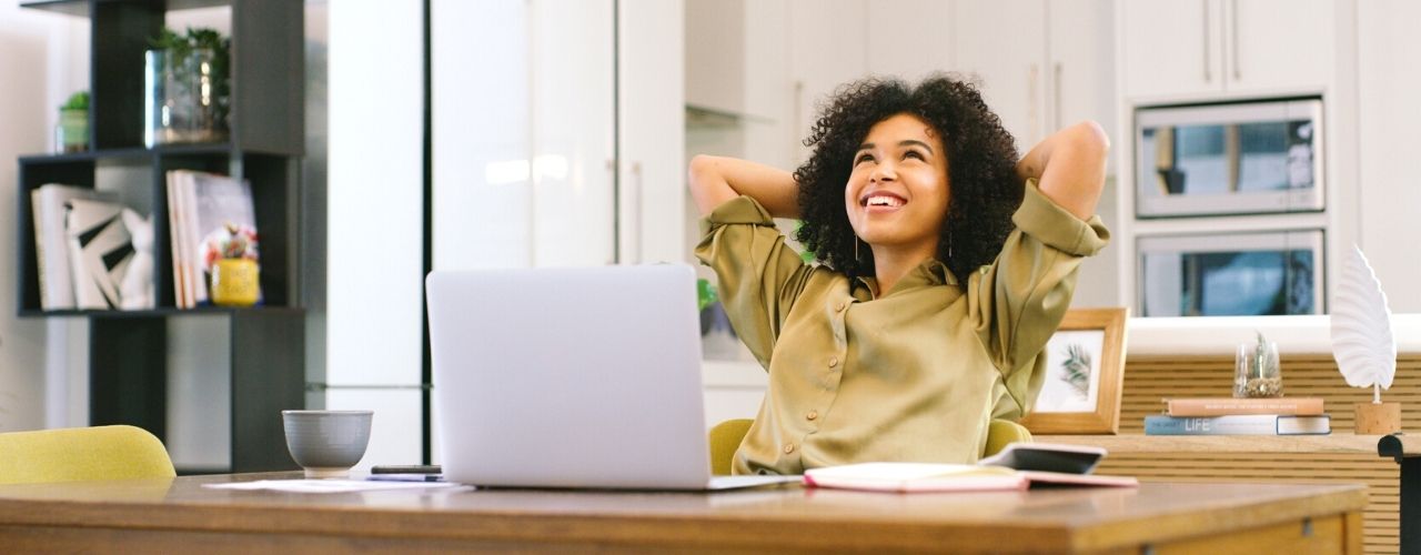 woman looking up from laptop