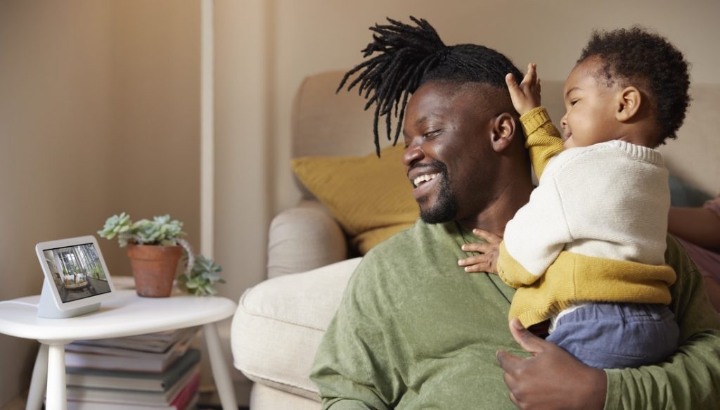 Father and child enjoying Nest Hub near the couch