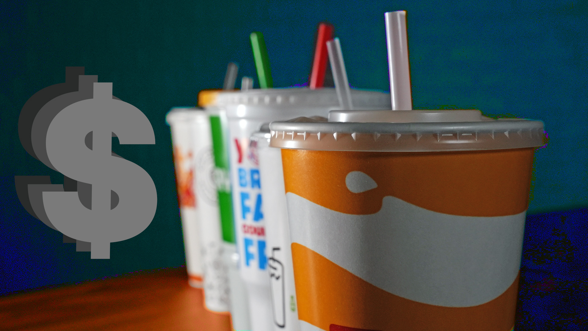 Soda cups lined up with dark background and money sign