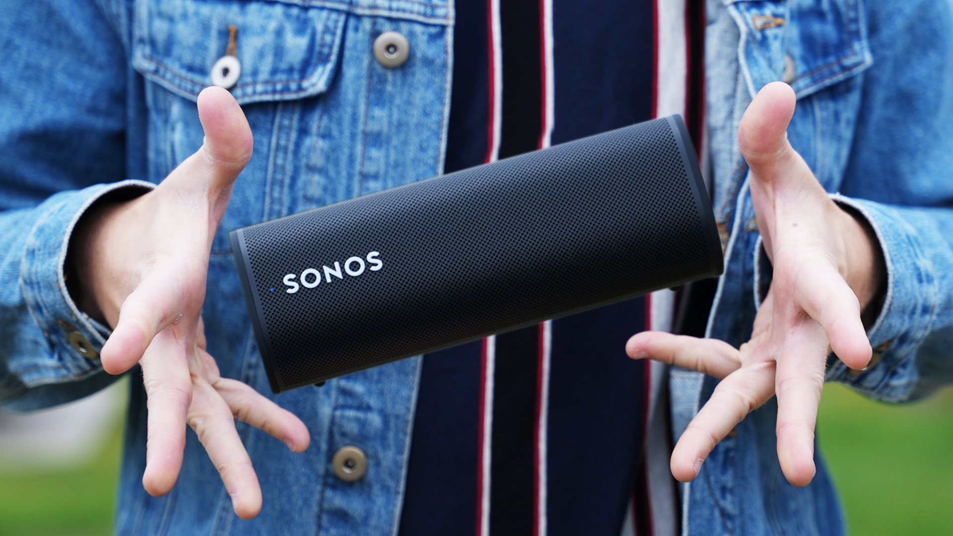 Sonos Roam Flying in the air hero hovering man's hands on either side