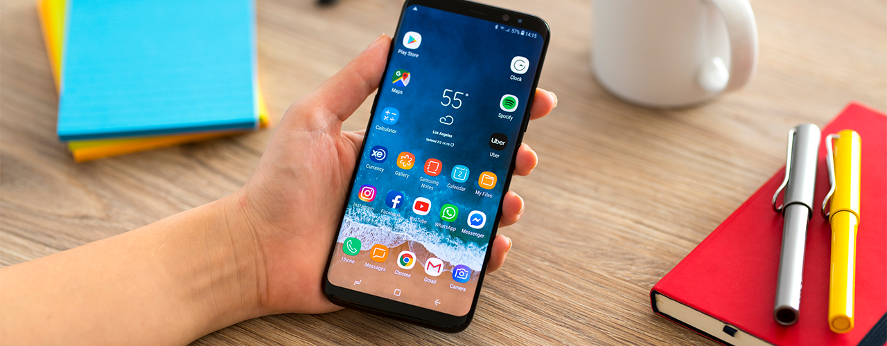 samsung galaxy s8 on desktop background with pen paper and coffee cup