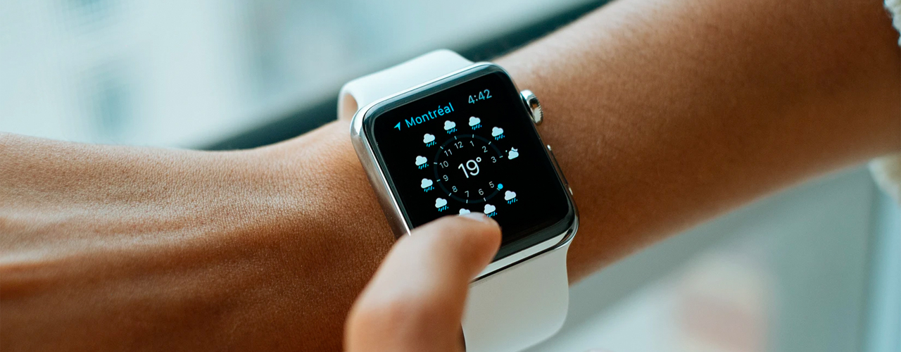 arm with apple watch showing Montreal weather on white background