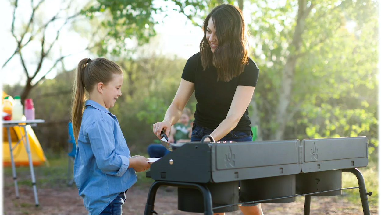 family cooking outdoors on a burner camping stove on sale