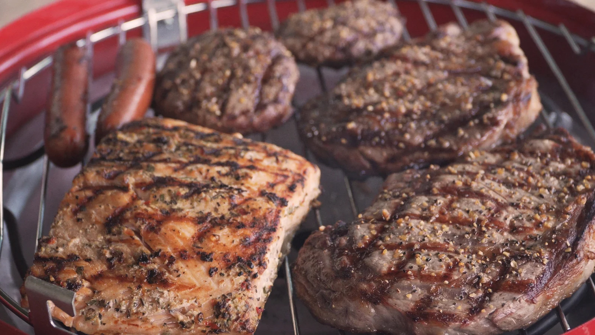 close up of grilled meat on grill steak salmon hot dogs