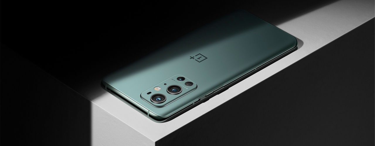 one plus 9 pro and white table on black background