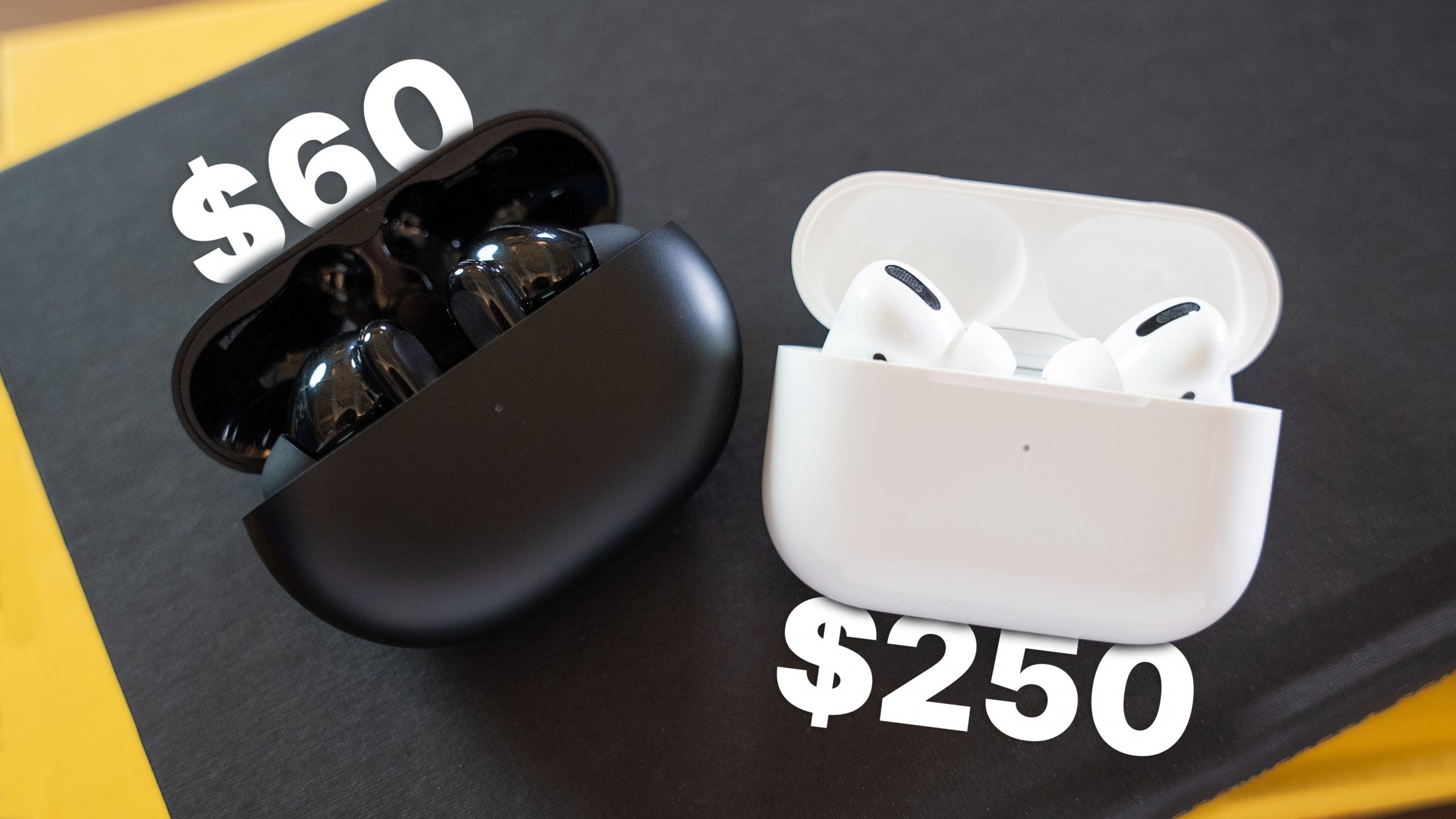 wyze buds pro and airpods pro on black book and yellow table with price tags
