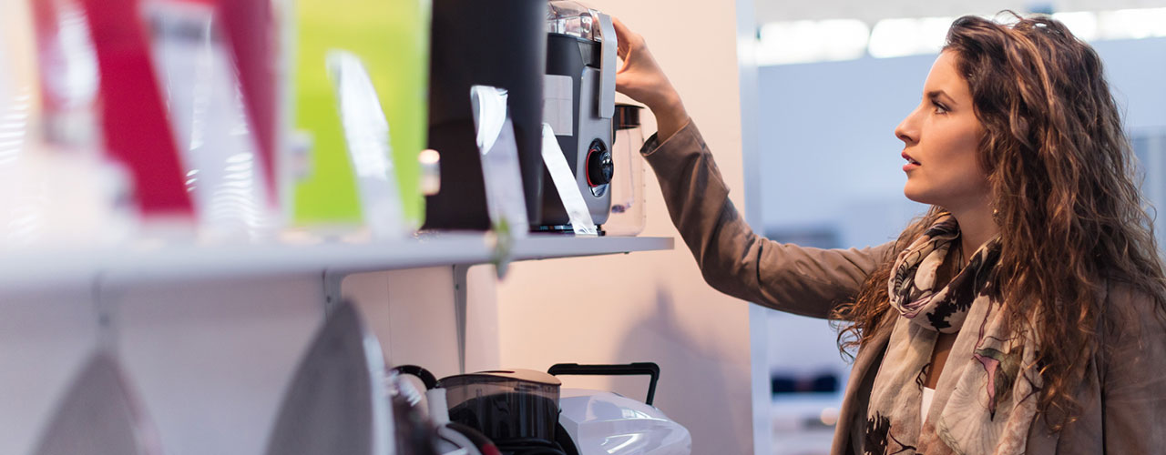 woman shopping for electronics in retail store
