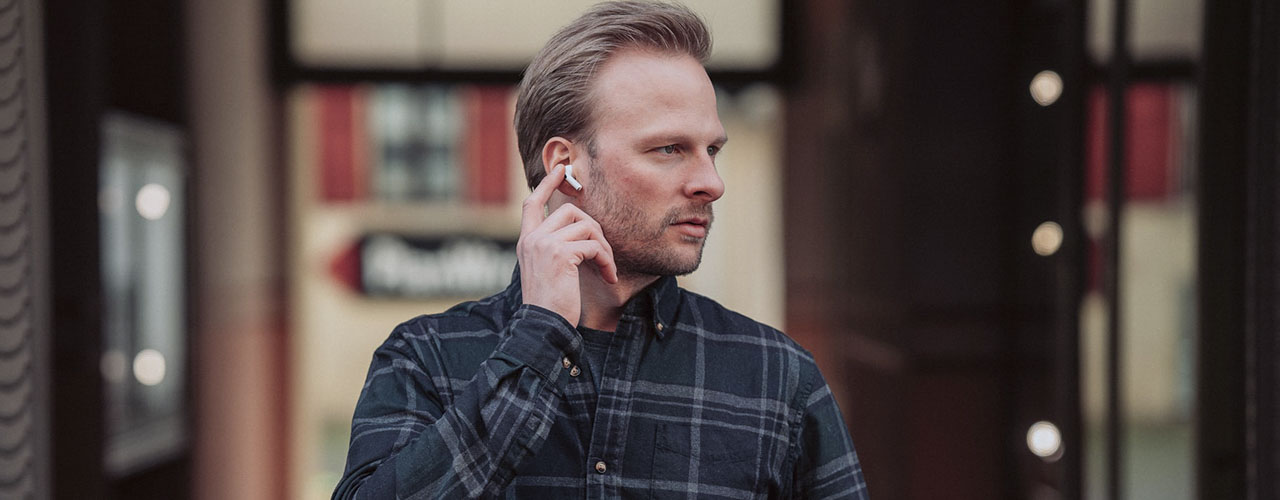 man tapping airpod