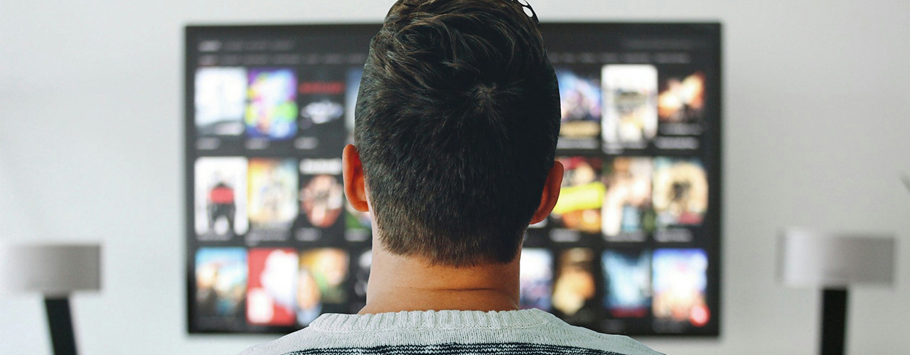 man's head in front of tv screen