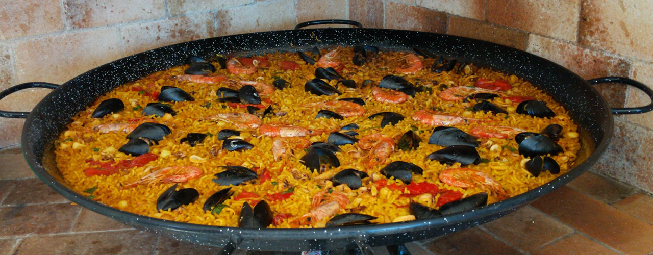 pan of paella food in home kitchen